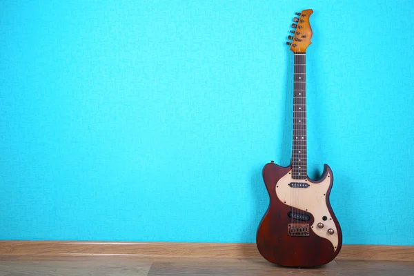 Electric guitar on blue wallpaper background