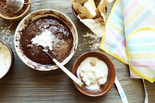 Preparing dough for chocolate pie on table close up