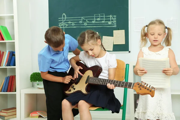 Cute pupils having music lesson