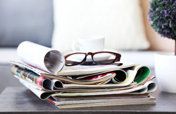 Magazines on table in living room, close up