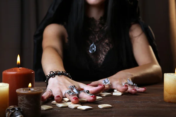 Witch - fortune teller on dark background