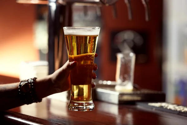 Woman holding beer glass