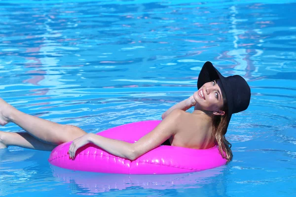 Woman resting on pink rubber ring