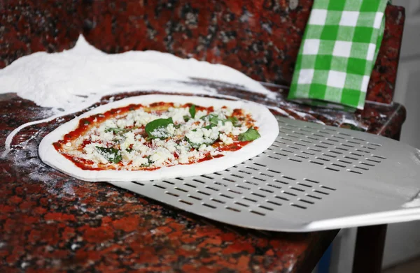 Preparing pizza on marble table, closeup