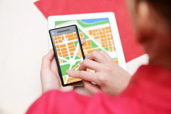 Woman holding smart phone with map
