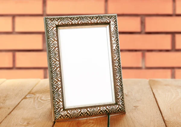 Old empty frame standing on table