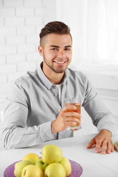 Man showing glass of apple juice