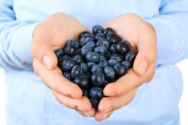 Female hand holding tasty ripe blueberries close up