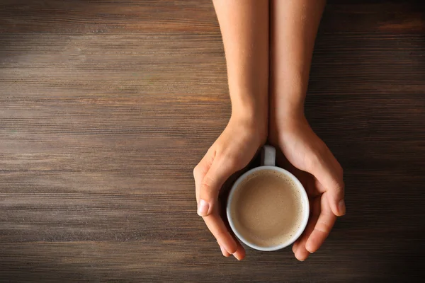 Hands holding cup of coffee