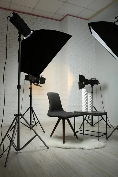 Photo studio with modern interior and lighting equipment