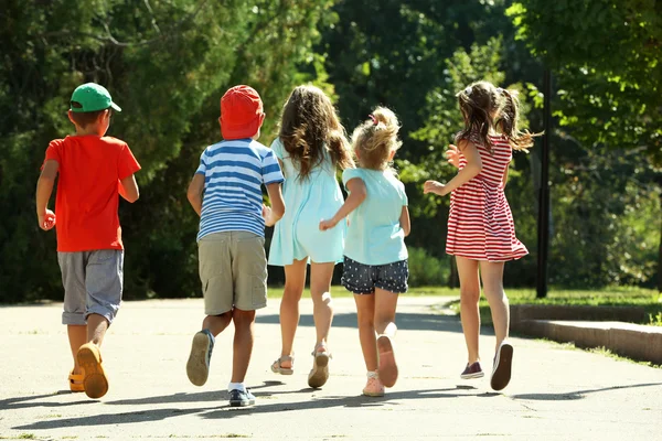 Happy active children running in park