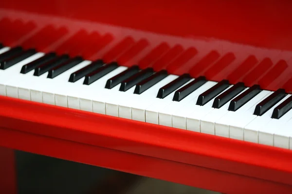 Piano keys of red piano close up