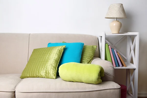 Colorful pillows on sofa, close-up, on home interior background