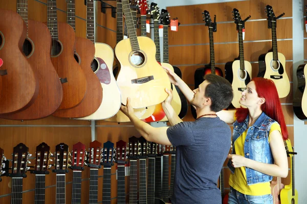 Beautiful young couple in music store