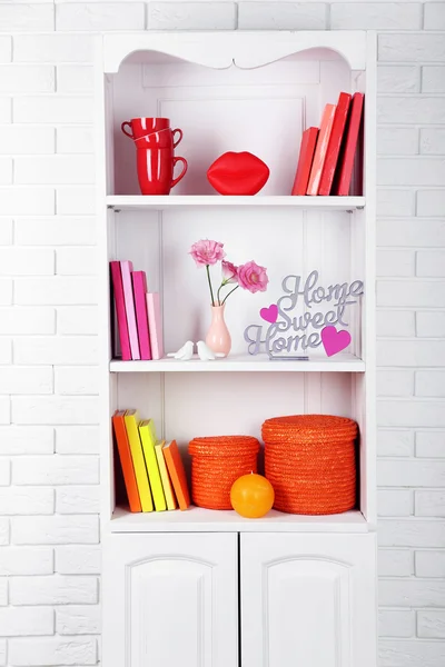 Books and decor in cupboard