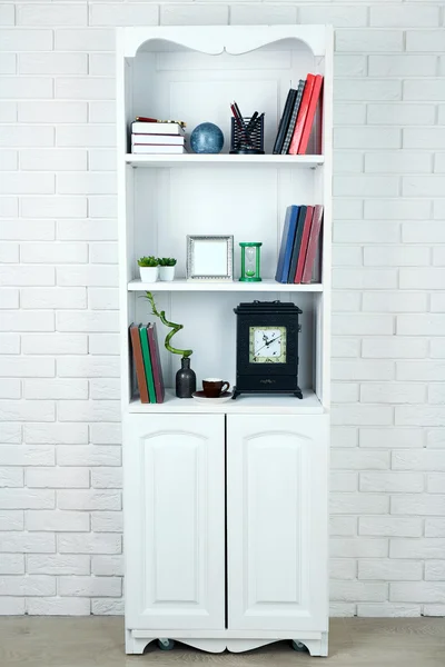 Books and decor in cupboard