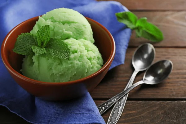 Homemade mint ice-cream on dark wooden background