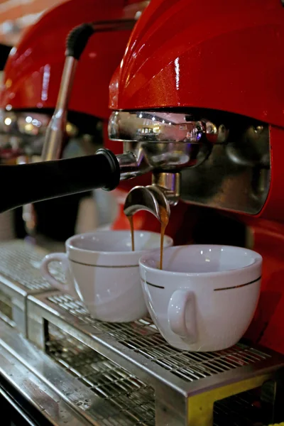 Coffee machine preparing cups of coffee close up
