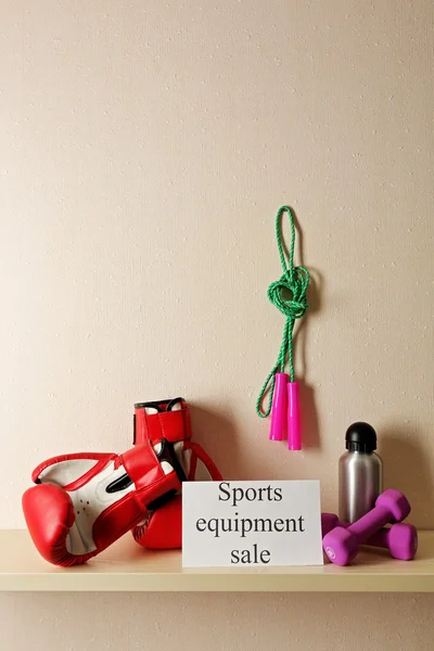 Sport goods for sale, on light wall background