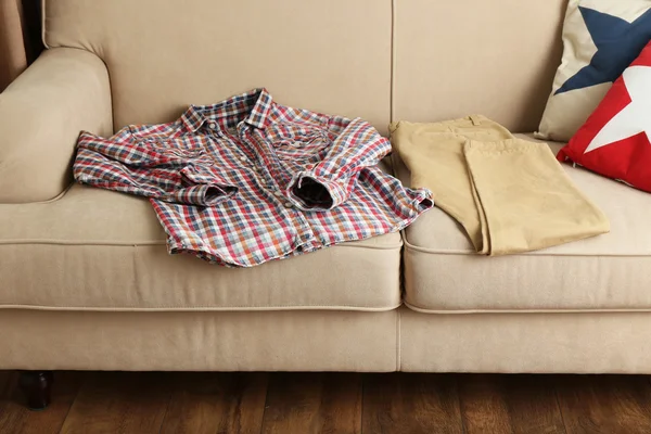 Male clothing on sofa in room