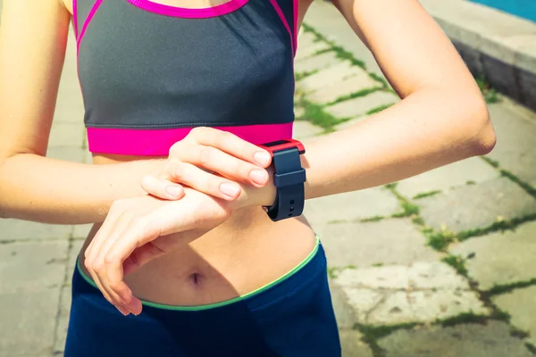 Runner looking at sports smart watch