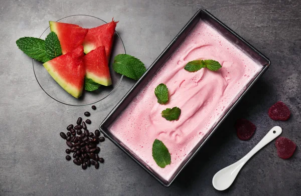 Homemade ice cream in frozen metallic container on k wooden background