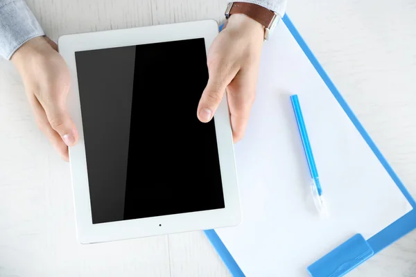 Man working with digital tablet, top view