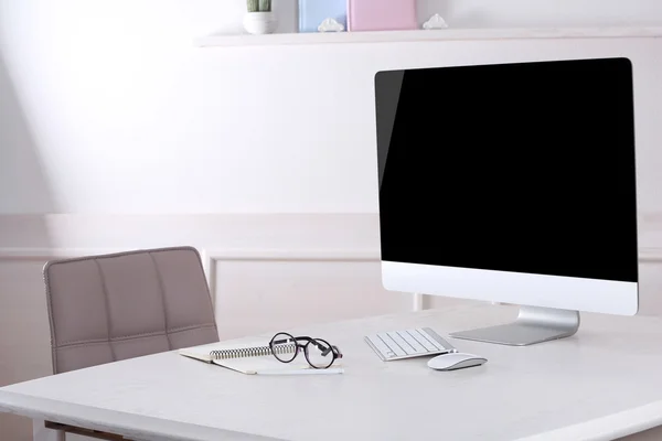 Workplace with computer in room