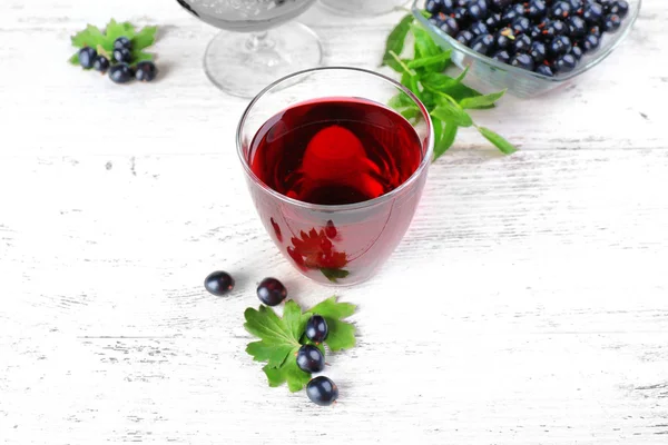 Fresh currant juice with berries on table close up