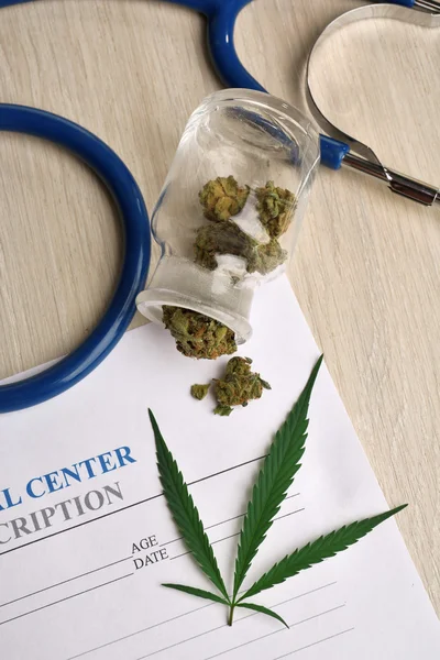 Medical prescription with dry cannabis on table close up