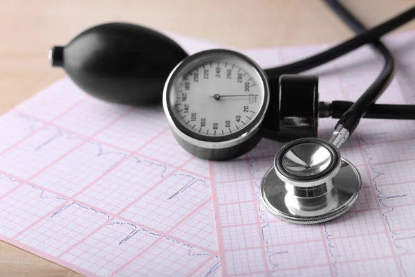 Blood pressure meter, digital tablet and stethoscope, on wooden background