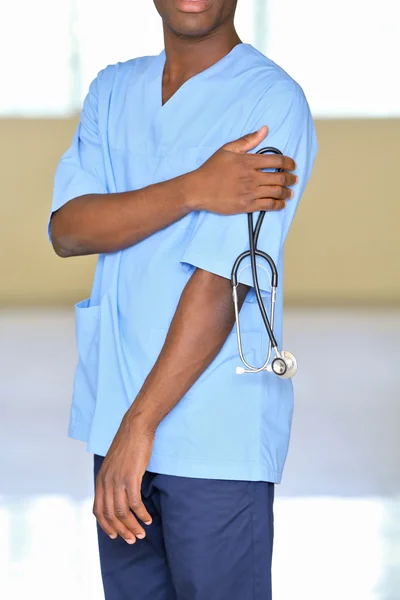 Handsome African American doctor with stethoscope in hospital