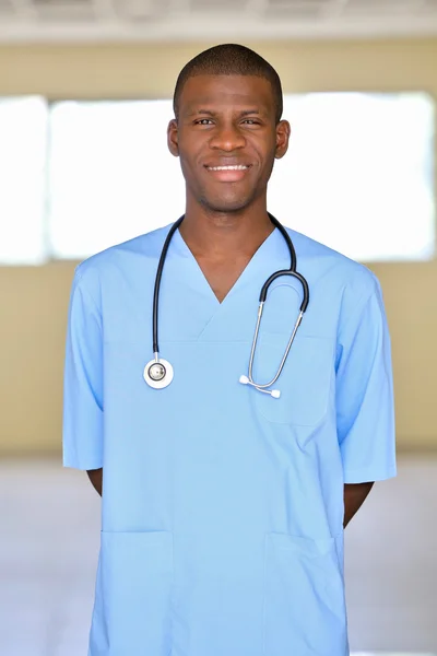 Handsome African American doctor with stethoscope in hospital