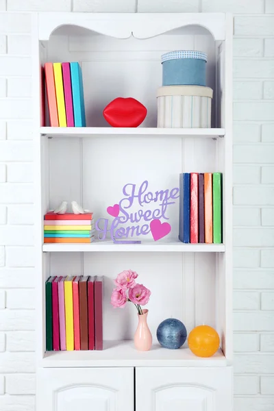 Books and decor on shelves in cupboard