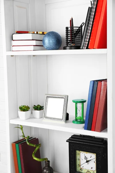 Books and decor on shelves in cupboard