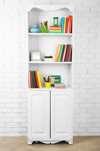 Books and decor on shelves in cupboard