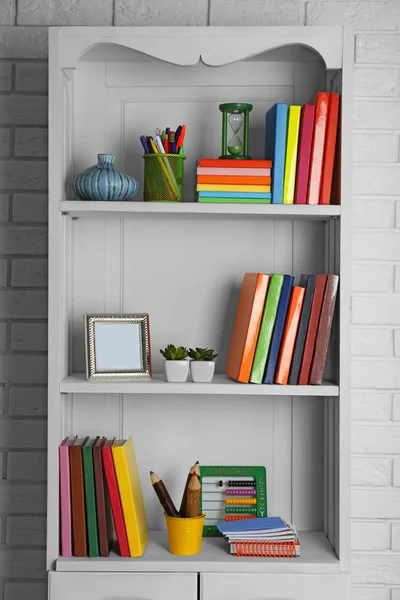 Books and decor on shelves in cupboard