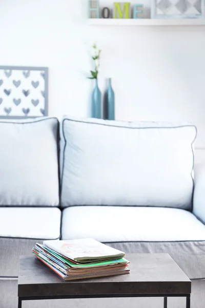 Magazines on table in living room, close up