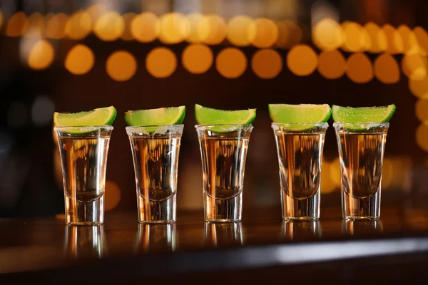 Shot glasses with tequila on bar counter