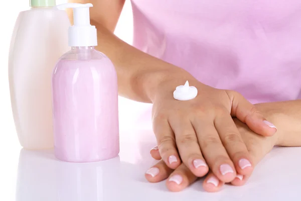 Women applying cream on her hands closeup