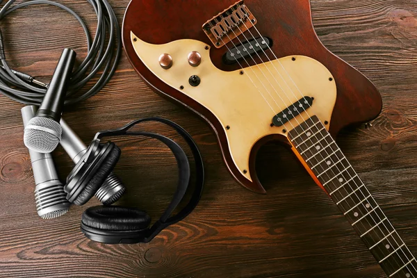 Electric guitar with microphones and headphones