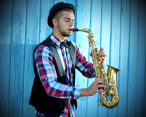 Young man playing on saxophone
