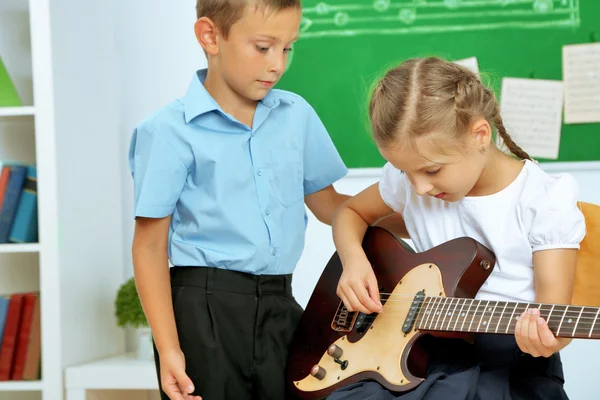 Cute pupils having music lesson