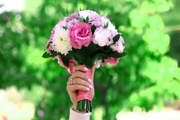 Beautiful wedding bouquet in hands of bride