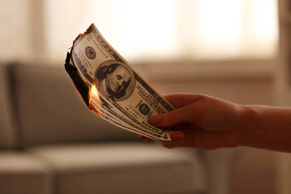 Woman burning dollars