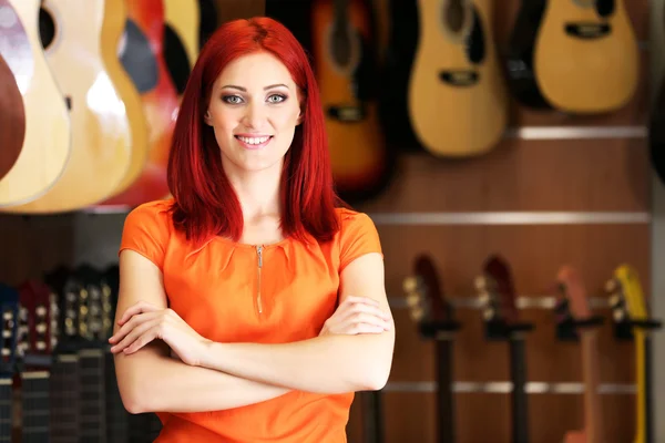 Beautiful young woman in music store