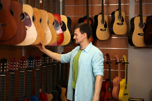 Handsome young man in music store