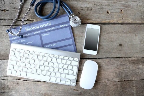 Medical still life with keyboard on wooden table