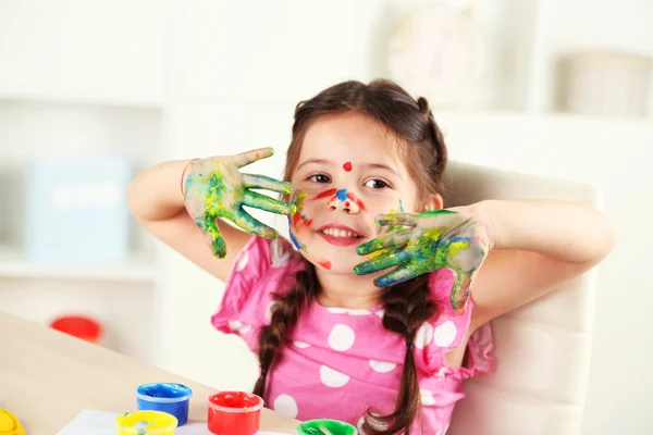 Cute little girl painting picture