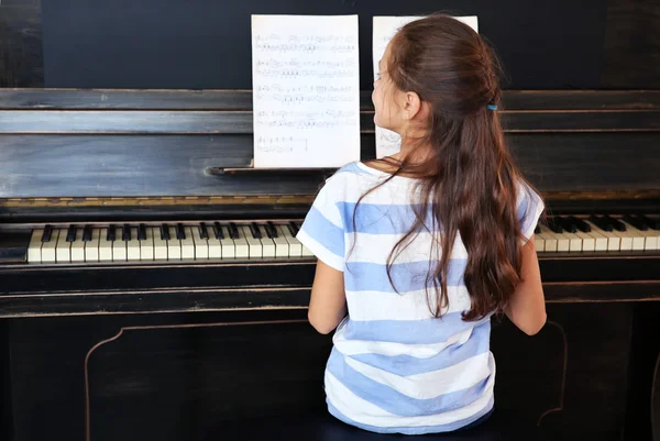 Musician girl plays piano